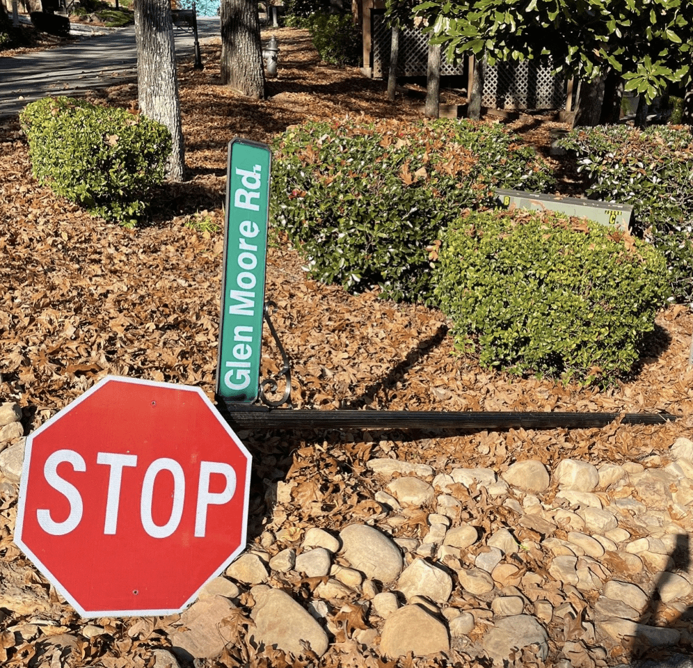 Damaged stop sign lying on the ground.